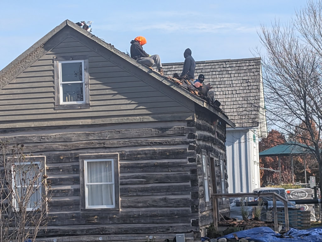 New shingles on the log cabin and hall